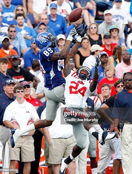 Carlos Singleton of the Memphis Tigers attempts to make a catch against Caussius Vaughn of the Ole Miss Rebels on September 6, 2009 at Liberty Bowl...