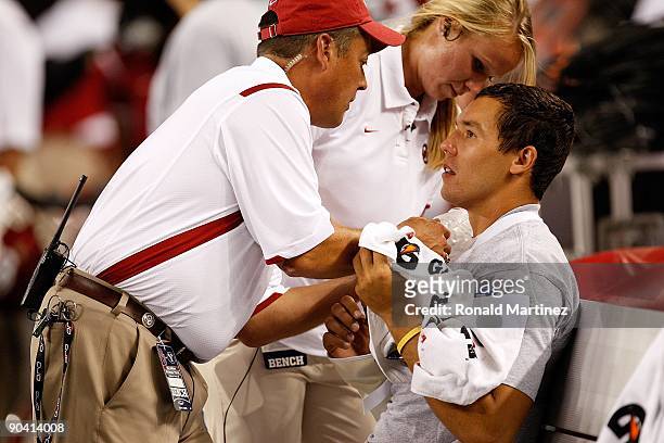 Quarterback Sam Bradford of the Oklahoma Sooners on the sidelines after suffering an injury against the Brigham Young Cougars at Cowboys Stadium on...
