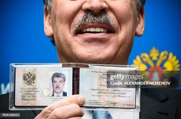 Communist Party candidate, businessman Pavel Grudinin shows his presidential candidate certificate shortly after receiving it at the Central Election...