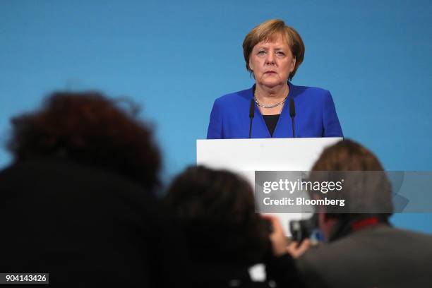 Angela Merkel, Germany's chancellor, pauses during a news conference following overnight coalition negotiations, at the Social Democratic Party...