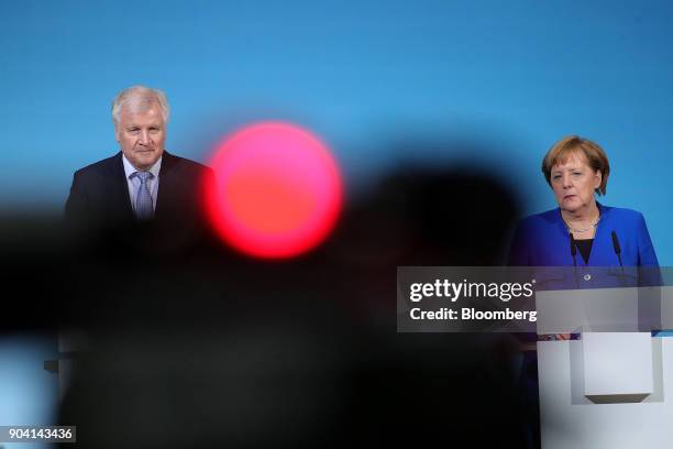 Horst Seehofer, leader of the Christian Social Union party, left, and Angela Merkel, Germany's chancellor, look on during a news conference following...