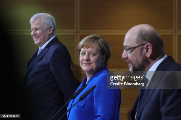 Angela Merkel, Germany's chancellor, looks towards Martin Schulz, leader of the Social Democrat Party , during a news conference following overnight...