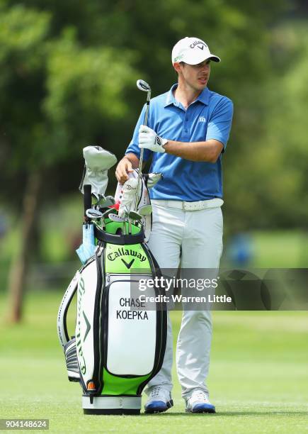 Chase Koepka of the United States takes a club from his bag on the 18th hole during day two of the BMW South African Open Championship at Glendower...