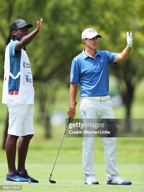 Chase Koepka of the United States talks with his caddie on the 18th hole during day two of the BMW South African Open Championship at Glendower Golf...