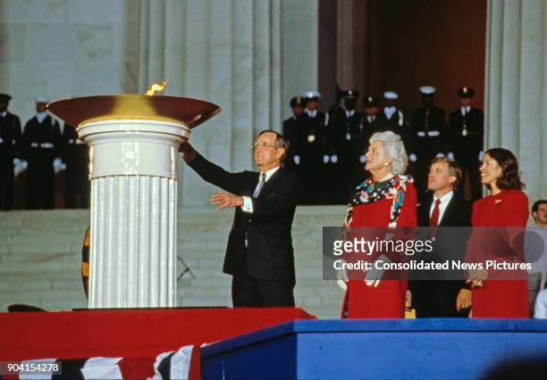 At the Lincoln Memorial, US President-Elect George HW Bush lights a ceremonial flame during his inaugural opening ceremony, Washington DC, January...