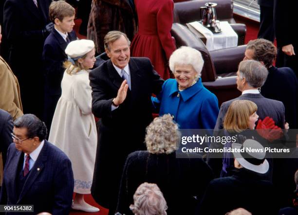 President George HW Bush and First Lady Barbara Bush smile as they walk among the crowd after the former's Inauguration at the US Capitol, Washington...