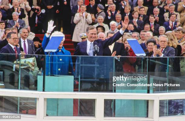 President George HW Bush waves as he delivers his Inaugural Address at the US Capitol, Washington DC, January 20, 1989. Waving beside him, though...