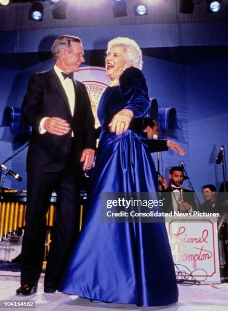 President George HW Bush and First Lady Barbara Bush share a laugh on stage during one of their Inaugural Balls, Washington DC, January 20, 1989.