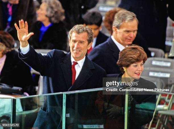 Campaign advisor George W Bush waves from the podium at his father's Presidential Inauguration ceremony at the US Capitol, Washington DC, January 20,...