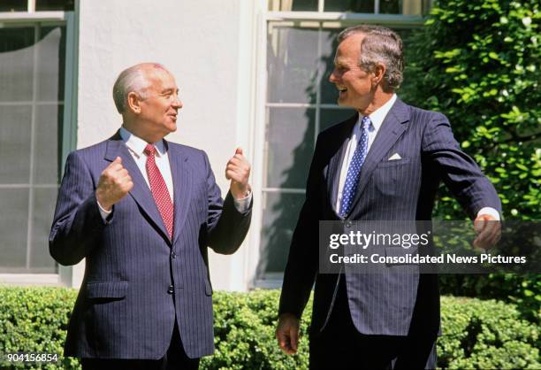 Soviet President Mikhail Gorbachev and US President George HW Bush talk together outside the White House during the arrival ceremony in honor of the...