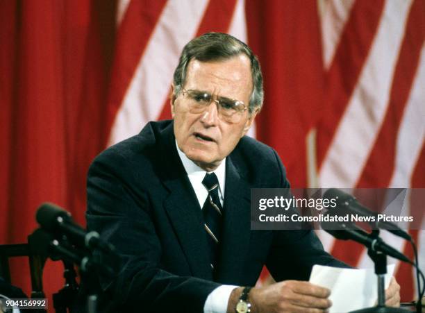 President George HW Bush speaks during a press conference in the White House's East Room, Washington DC, June 3, 1990. Seated beside him, but not...