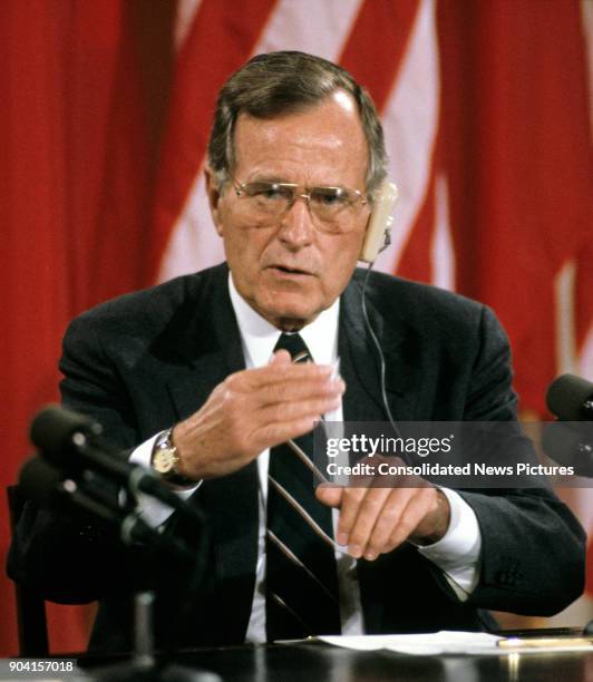 President George HW Bush speaks during a press conference in the White House's East Room, Washington DC, June 3, 1990. Seated beside him, but not...