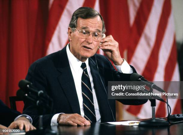 President George HW Bush speaks during a press conference in the White House's East Room, Washington DC, June 3, 1990. Seated beside him, but not...