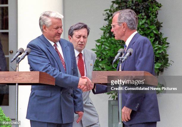 Russian President Boris Yeltsin and US President George HW Bush shake hands during a press conference in the White House's Rose Garden, Washington...