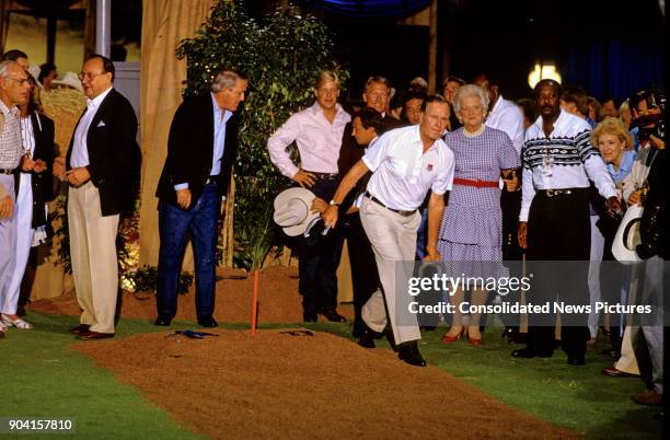 President George HW Bush plays a game of horseshoes during a reception prior to the 16th G7 Summit , Houston, Texas, July 8, 1990. Among those in the...