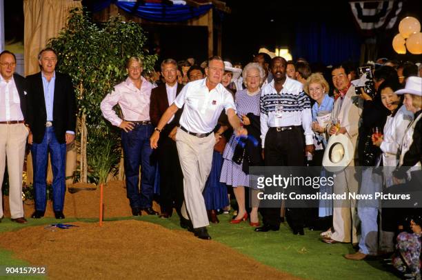 President George HW Bush plays a game of horseshoes during a reception prior to the 16th G7 Summit , Houston, Texas, July 8, 1990. Among those in the...