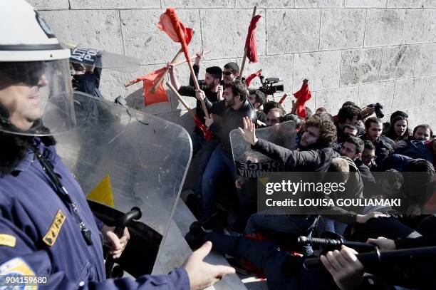 Leftist protesters clash with police as they try to take the stairs leading to the parliament building in Athens on January 12 as part of a strike...