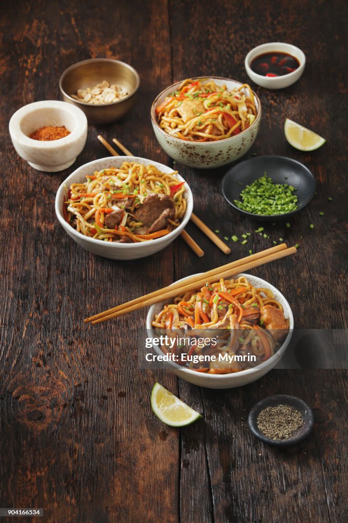 Bowls with chicken, beef and vegetables chow mein