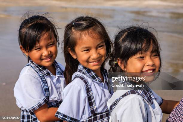vietnamese schoolgirls on a beach, vietnam - vietnam school stock pictures, royalty-free photos & images
