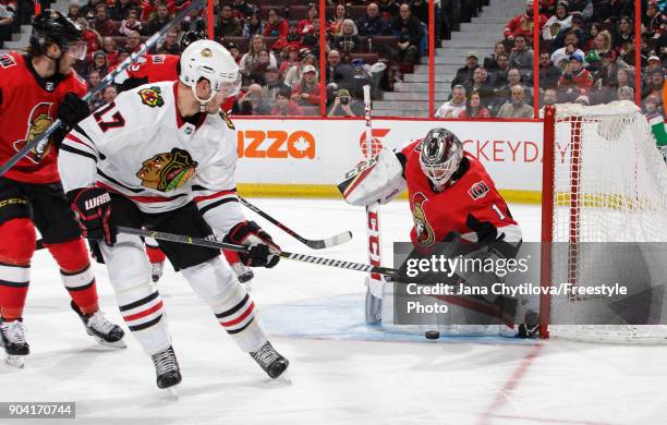 Mike Condon of the Ottawa Senators makes a pad save against Lance Bouma of the Chicago Blackhawks at Canadian Tire Centre on January 9, 2018 in...