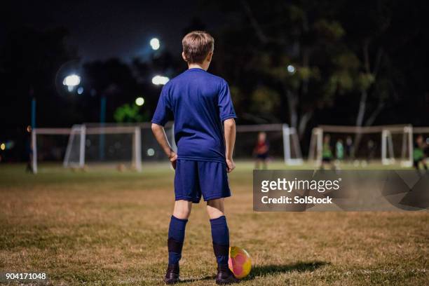 young soccer player - boy playing soccer stock pictures, royalty-free photos & images
