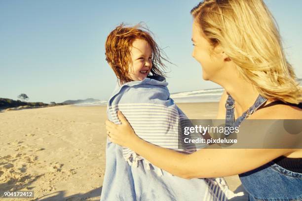 beach time is bonding time - wrapped in a towel stock pictures, royalty-free photos & images