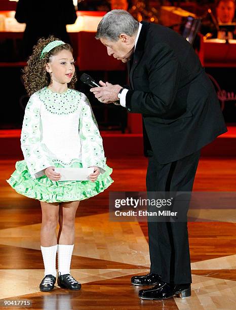 Maggie Nowakowski of the Trinity Irish Dancers gives entertainer Jerry Lewis a check during the 44th annual Labor Day Telethon to benefit the...