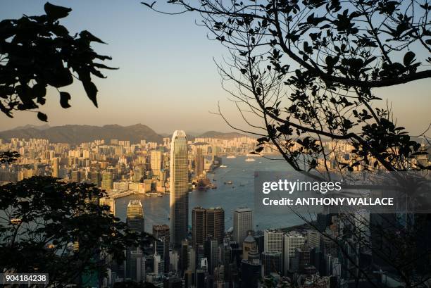 General view taken from the Peak shows a view of Victoria Harbour and the skylines of the Kowloon district and Hong Kong island on January 12, 2018....