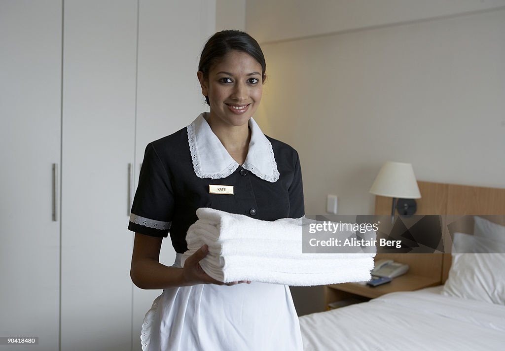 Portrait of maid in hotel room