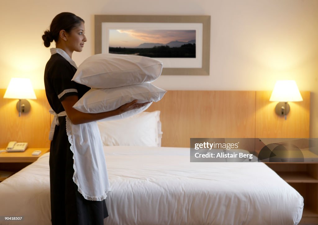 Chamber maid in hotel room