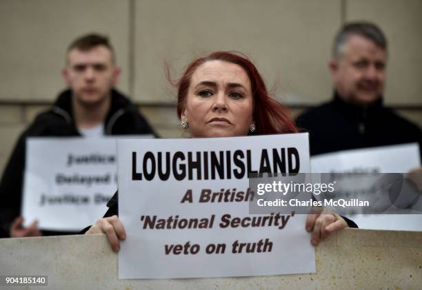 Loughinisland victim protestors stand with placards and banners outside Belfast High Court on January 12, 2018 in Belfast, Northern Ireland. The...