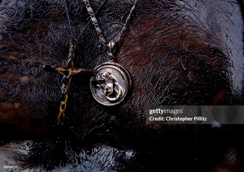 Religious icons being worn around man's neck