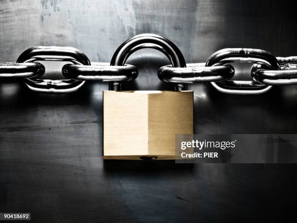 strong steel chain held together with padlock - padlock stock pictures, royalty-free photos & images