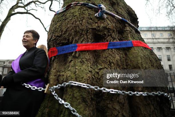 Vicar of St Pancras church Anne Stevens, along another protester is chained to a tree outside Euston Station on January 12, 2018 in London, England....