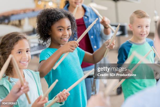 elementary students learn to play percussion instruments - drum percussion instrument stock pictures, royalty-free photos & images