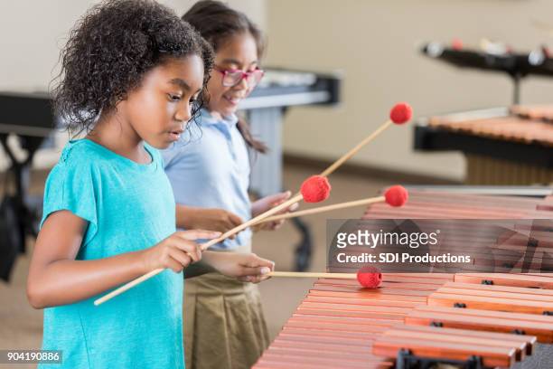 girl concentrates while playing marimba - marimba stock pictures, royalty-free photos & images