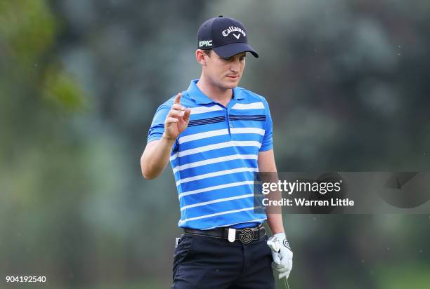 Chris Paisley of England acknowledges the crowd after his second shot on the 18th hole during day two of the BMW South African Open Championship at...