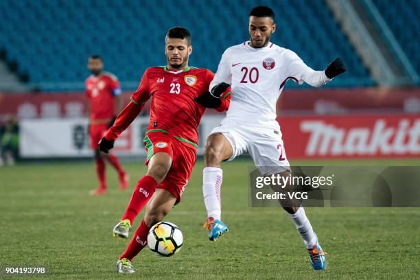 Ibrahim Al Sawwafi of Oman and Salem Al Hajri of Qatar compete for the ball during the AFC U-23 Championship Group A match between Oman and Qatar at...