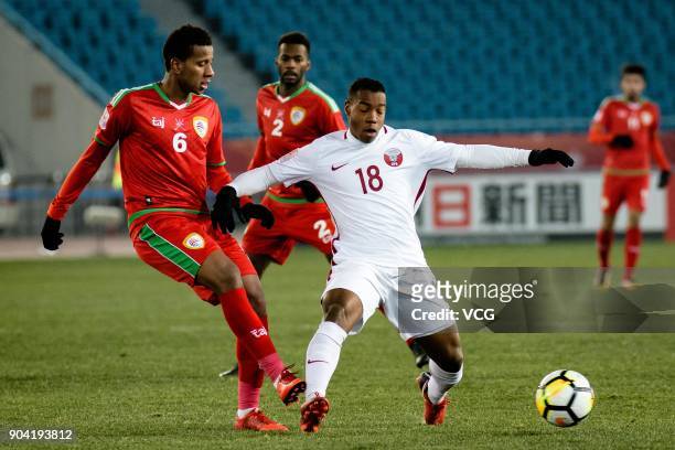 Abdullah Fawaz of Oman and Assim Madibo of Qatar compete for the ball during the AFC U-23 Championship Group A match between Oman and Qatar at...