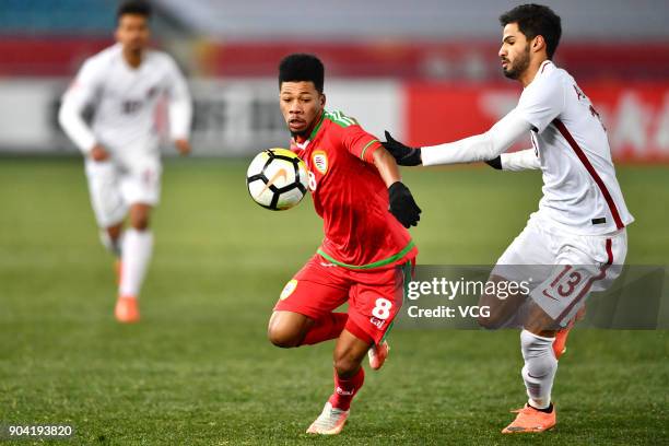 Jameel Al Yahmadi of Oman and Sultan Al Brake of Qatar compete for the ball during the AFC U-23 Championship Group A match between Oman and Qatar at...