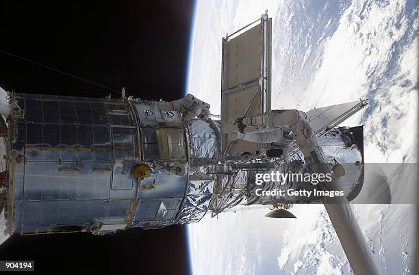 Astronaut John M. Grunsfeld works to replace the starboard solar array on the Hubble Space Telescope March 4, 2002 during an extravehicular activity...