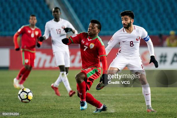 Al Mandhar Al Alawi of Oman and Ahmad Moein of Qatar compete for the ball during the AFC U-23 Championship Group A match between Oman and Qatar at...