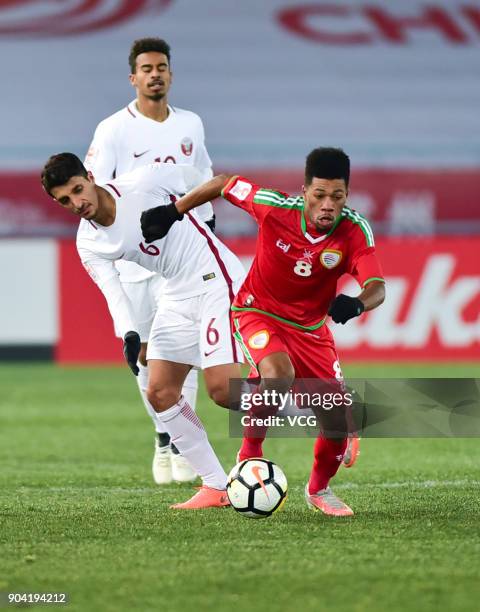 Jameel Al Yahmadi of Oman and Abdullah Al Ahrak of Qatar compete for the ball during the AFC U-23 Championship Group A match between Oman and Qatar...