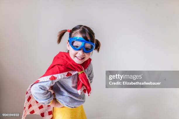 portrait of a smiling girl dressed as a superhero - swimming goggles stock pictures, royalty-free photos & images