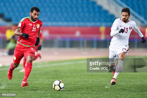 Abdulaziz Al Gheilani of Oman and Sultan Al Brake of Qatar follow the ball during the AFC U-23 Championship Group A match between Oman and Qatar at...