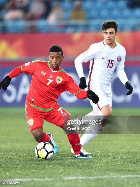 Al Mandhar Al Alawi of Oman and Bassam Al Rawi of Qatar compete for the ball during the AFC U-23 Championship Group A match between Oman and Qatar at...