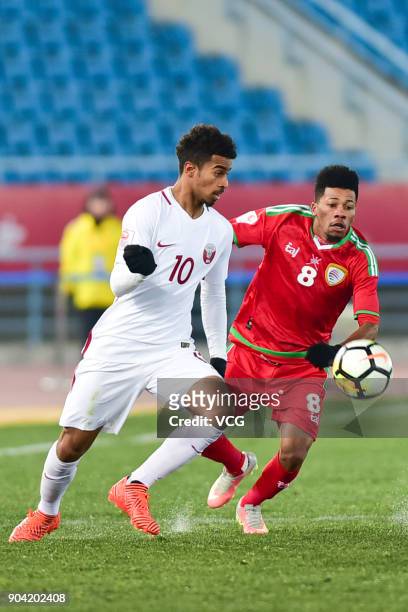 Jameel Al Yahmadi of Oman and Akram Afif of Qatar compete for the ball during the AFC U-23 Championship Group A match between Oman and Qatar at...