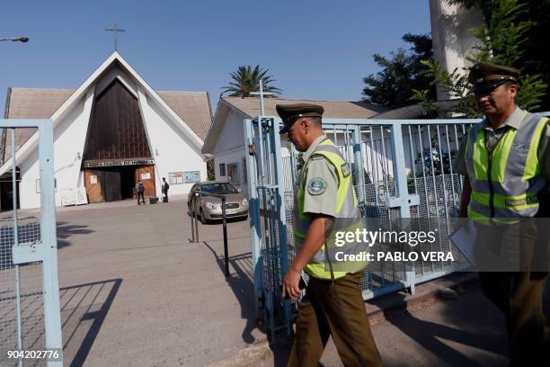 Police personnel work in the scene where an attack with an incendiary device occured and a threating message against the pontiff was placed at the...