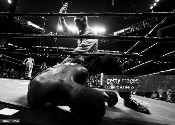 Charles Hatley is knocked out in the sixth round by Jermell Charlo during their WBC junior middleweight title bout at the Barclays Center on April...