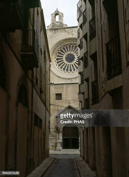 Reus, province of Tarragona, region El Baix Camp, Catalonia, Spain. Abadia street in the old town. At the bottom, Church of St. Peter , built in 16th...